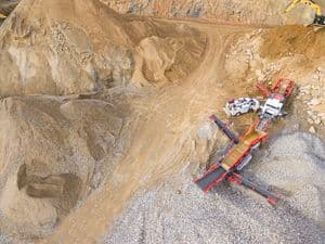 An aerial view of a quarry with heavy machinery and excavation equipment